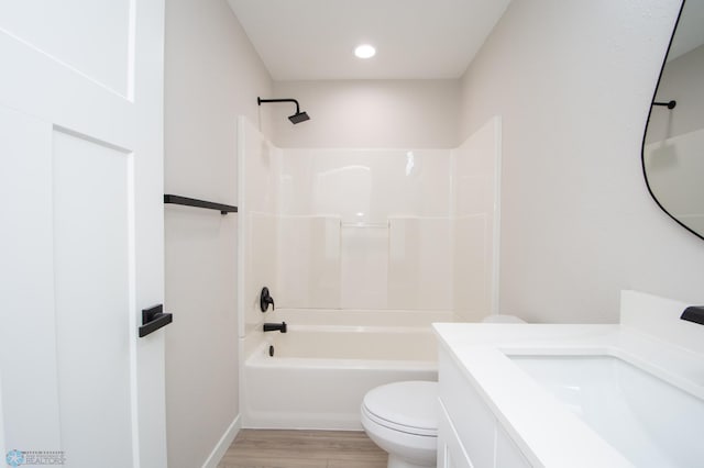 bathroom with vanity, bathing tub / shower combination, toilet, and wood finished floors