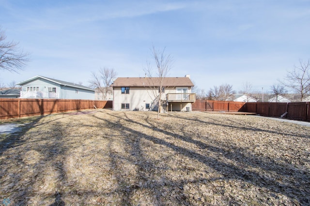 back of property featuring a deck, stairs, and a fenced backyard