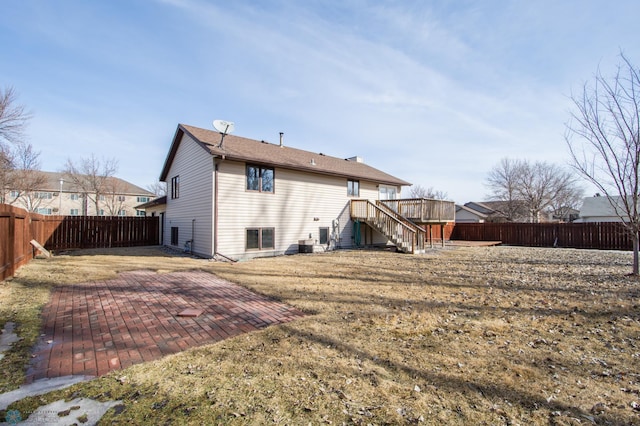 back of property with a fenced backyard, stairway, a patio, and a deck