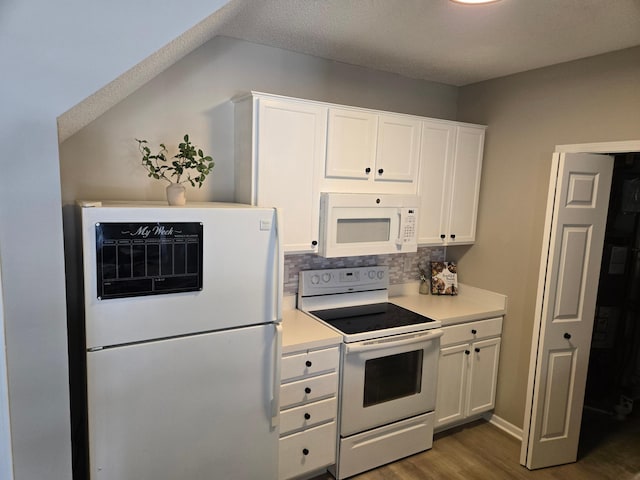 kitchen featuring light countertops, decorative backsplash, white appliances, white cabinetry, and dark wood-style flooring