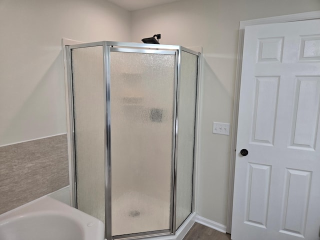 bathroom with a garden tub and a stall shower