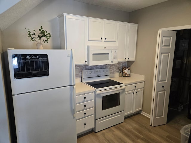 kitchen with white cabinetry, white appliances, wood finished floors, and light countertops