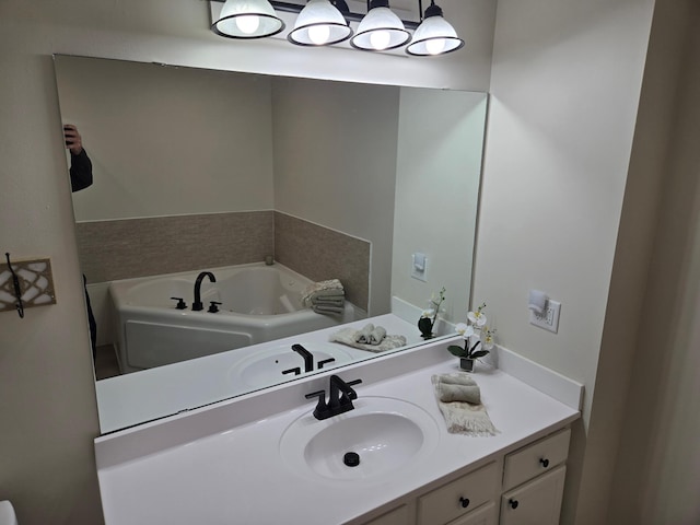 bathroom with vanity and a garden tub