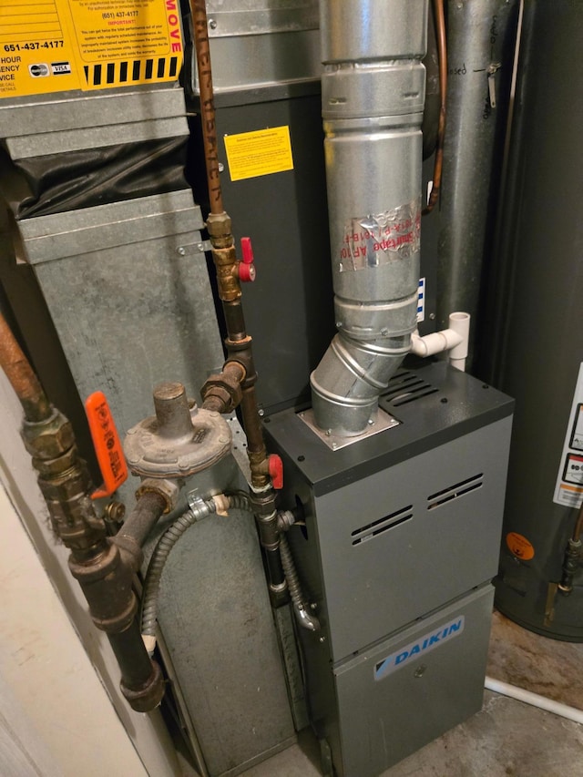 utility room featuring water heater