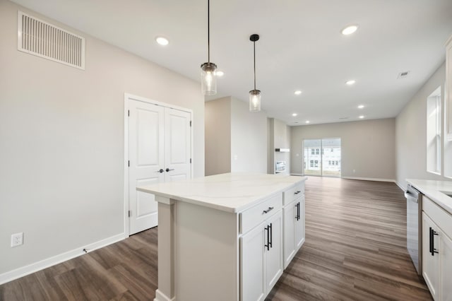 kitchen featuring a center island, dark wood-style flooring, visible vents, and stainless steel dishwasher