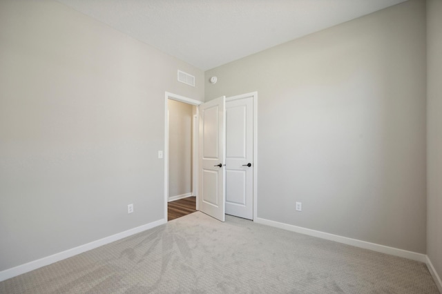 unfurnished bedroom with visible vents, baseboards, and carpet flooring