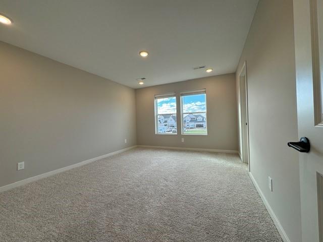 empty room with recessed lighting, carpet flooring, and baseboards