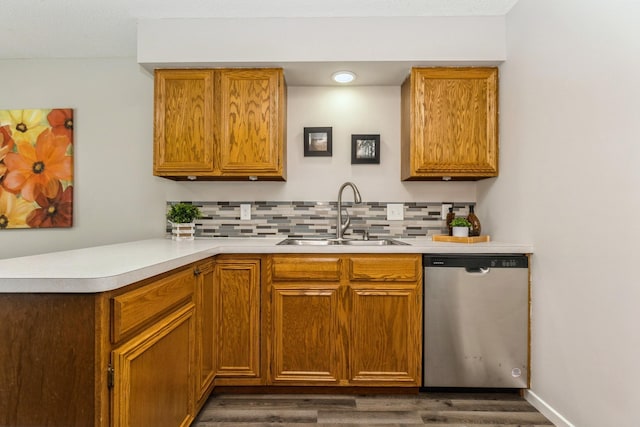 kitchen with tasteful backsplash, light countertops, dishwasher, and a sink