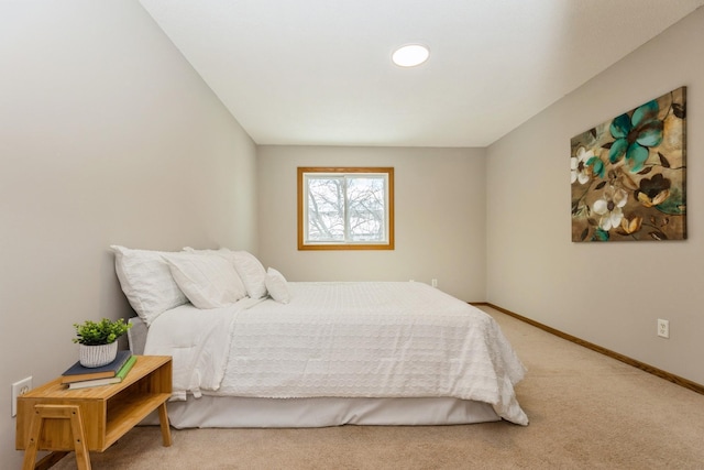 bedroom featuring light carpet and baseboards