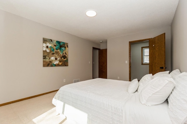 bedroom with light colored carpet, visible vents, and baseboards