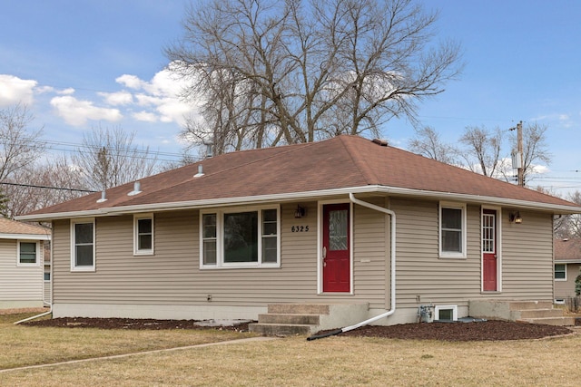 view of front of home with a front yard and roof with shingles