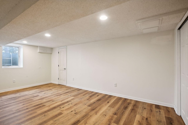 basement with recessed lighting, baseboards, and light wood-style flooring