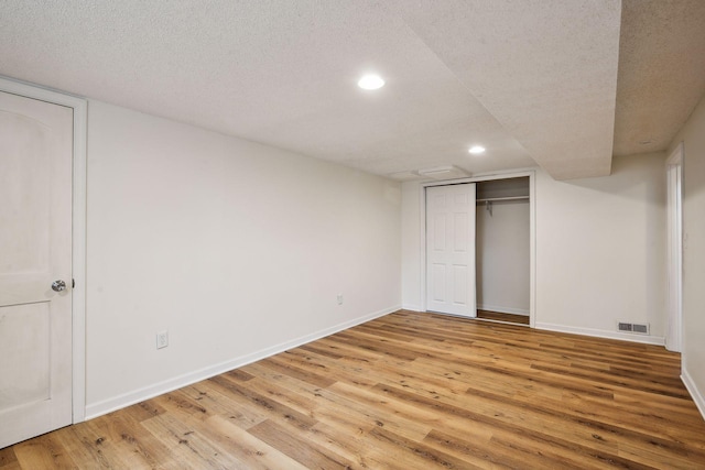 unfurnished bedroom with baseboards, visible vents, recessed lighting, a textured ceiling, and light wood-type flooring