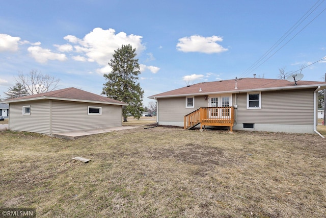 rear view of property with a patio area, a lawn, and a wooden deck