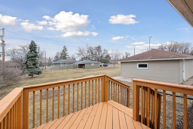 wooden terrace with a yard and fence