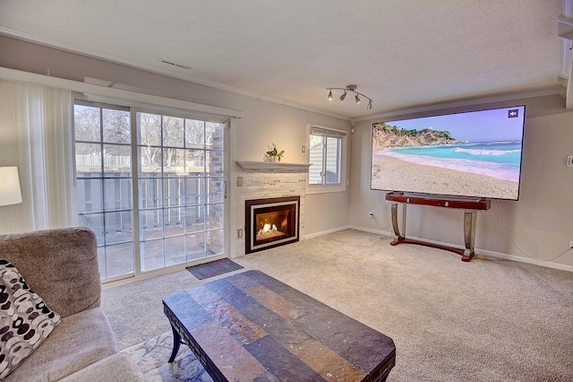 living room with a textured ceiling, a brick fireplace, carpet flooring, and ornamental molding