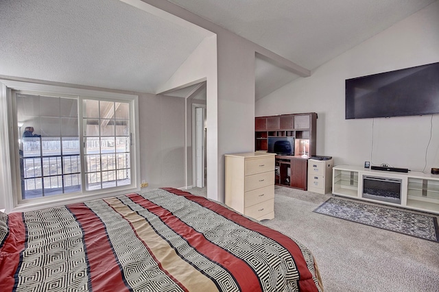 carpeted bedroom featuring a textured ceiling and vaulted ceiling