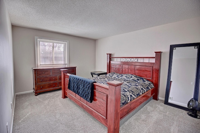 carpeted bedroom with a textured ceiling and baseboards