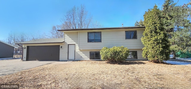 split level home with driveway and a garage