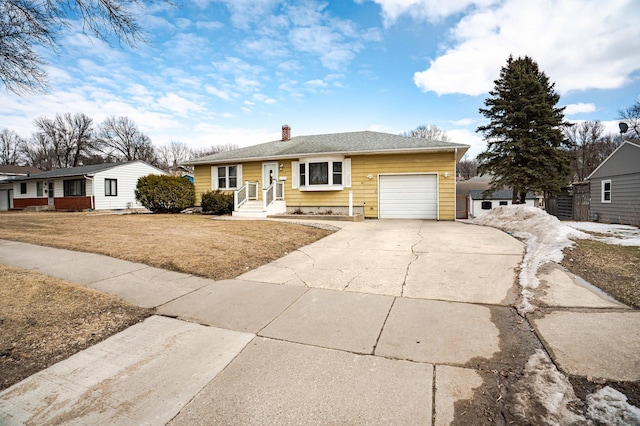 ranch-style house featuring a garage, driveway, a chimney, and a front lawn