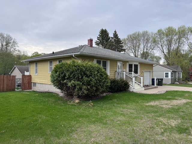 view of front of home with an attached garage, a chimney, and concrete driveway