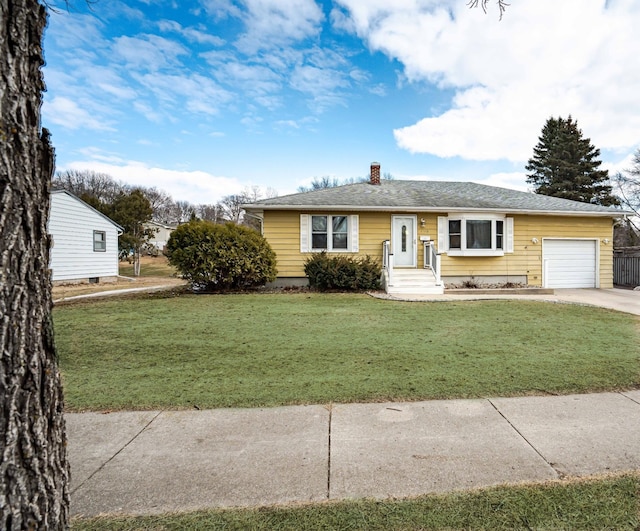 view of front of property featuring a garage, a front yard, a chimney, and driveway