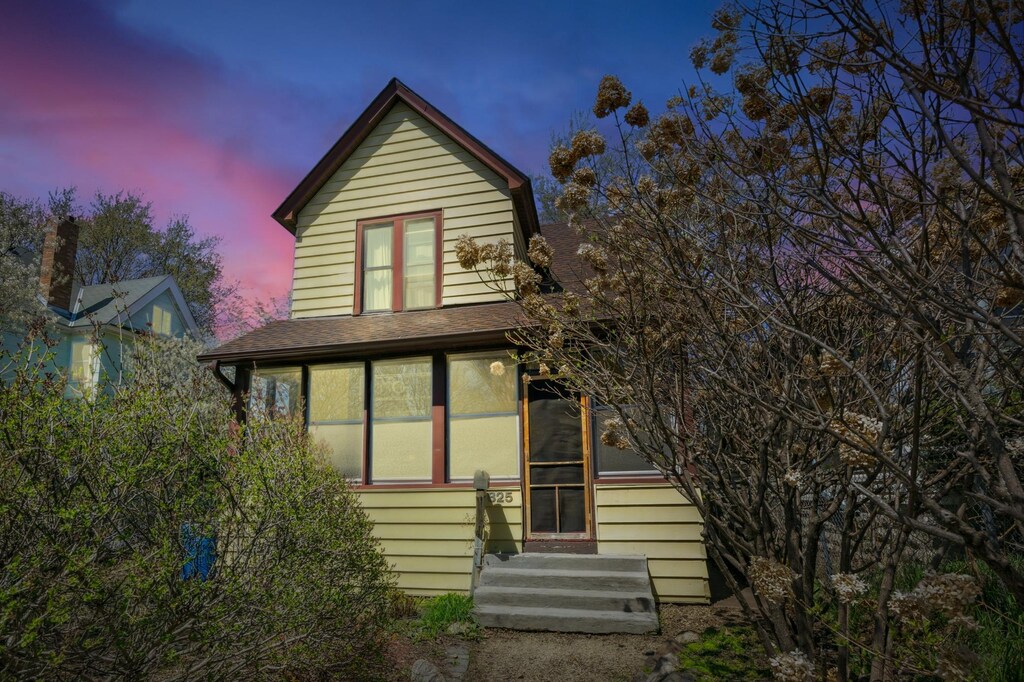 825 Charles Ave, Saint Paul, MN 55104 - back of house at dusk with roof with shingles