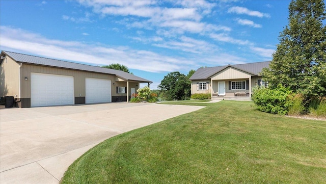 view of front facade with a garage, metal roof, and a front lawn