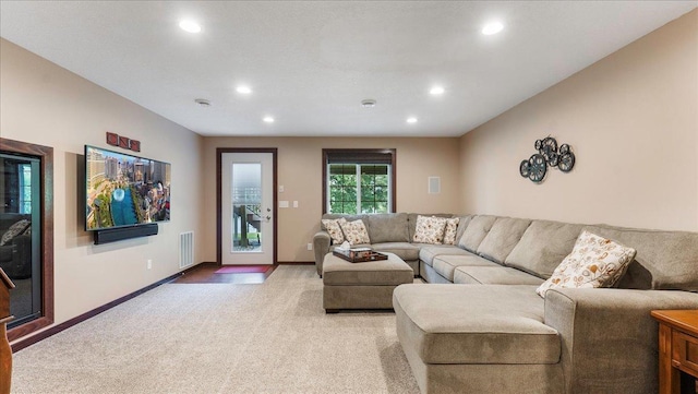 living area with recessed lighting, visible vents, light carpet, and baseboards