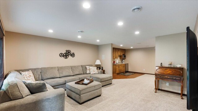 living room featuring light carpet, recessed lighting, visible vents, and baseboards