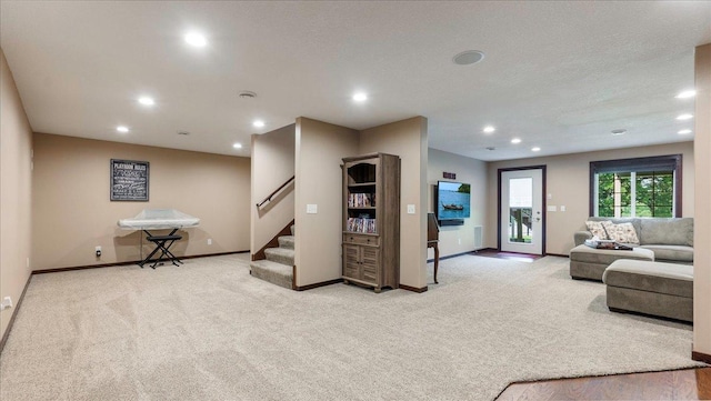 carpeted living room featuring stairway, recessed lighting, and baseboards