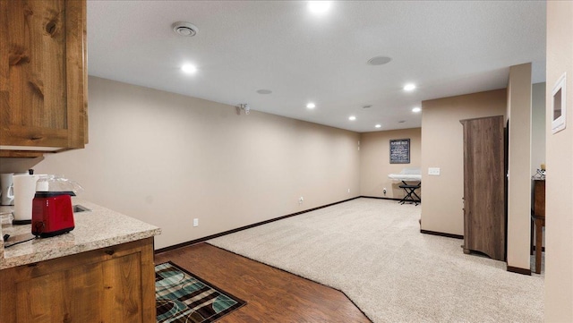 kitchen featuring light countertops, recessed lighting, and baseboards