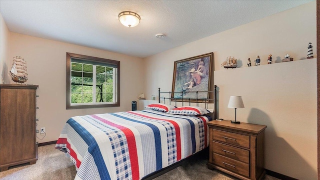 carpeted bedroom featuring baseboards and a textured ceiling