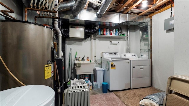 washroom featuring washer and dryer, electric water heater, laundry area, and a sink