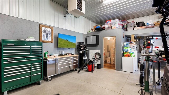 garage with metal wall and a workshop area