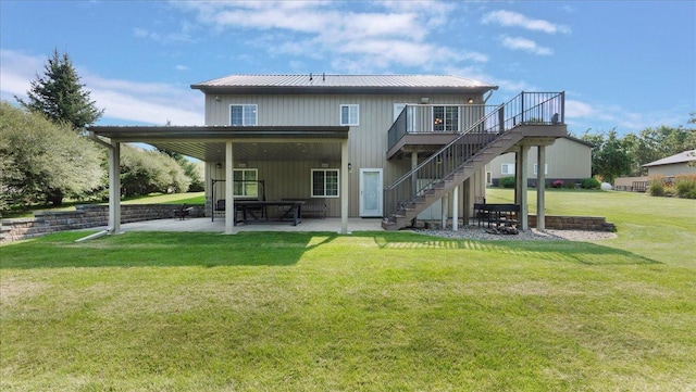 rear view of house with stairs, a patio, a yard, and a wooden deck