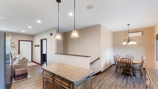 41032 Sauk Lake Rd, Sauk Centre, MN 56378 - kitchen featuring an inviting chandelier, freestanding refrigerator, recessed lighting, a wall mounted AC, and light wood-style flooring