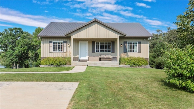 41032 Sauk Lake Rd, Sauk Centre, MN 56378 - bungalow with covered porch, a front yard, and metal roof