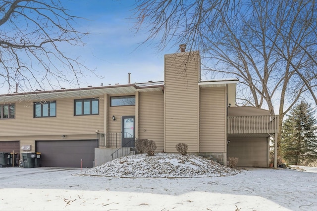 view of front of home with a garage and a chimney