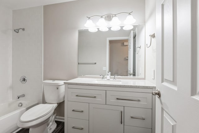 bathroom featuring toilet, tub / shower combination, and vanity