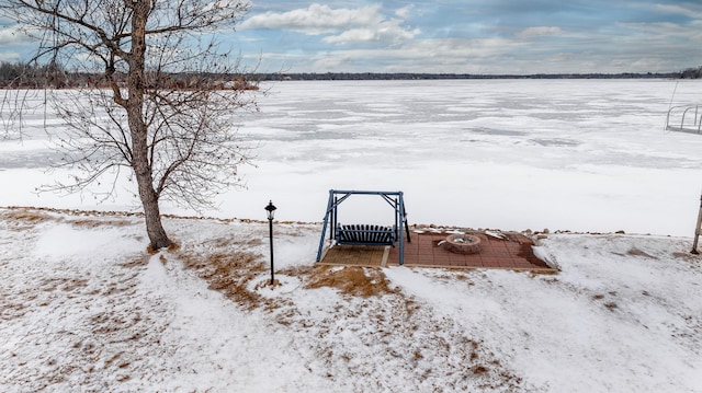 yard layered in snow featuring a dock