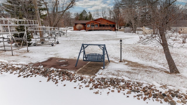 yard covered in snow featuring a deck