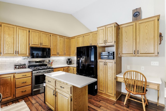 kitchen with dark wood-type flooring, vaulted ceiling, light countertops, decorative backsplash, and black appliances