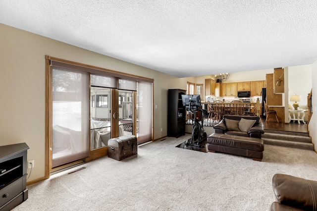 carpeted living area featuring visible vents, baseboards, a textured ceiling, and french doors