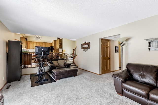 living room featuring light carpet, baseboards, stairs, a textured ceiling, and a chandelier