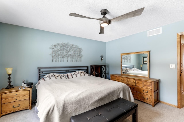 bedroom featuring carpet, visible vents, ceiling fan, a textured ceiling, and baseboards