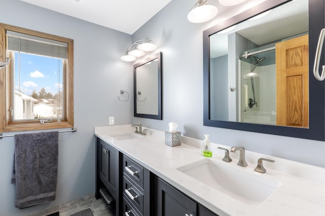 full bathroom with double vanity and a sink