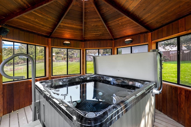 unfurnished sunroom with vaulted ceiling with beams, wood ceiling, and a jacuzzi