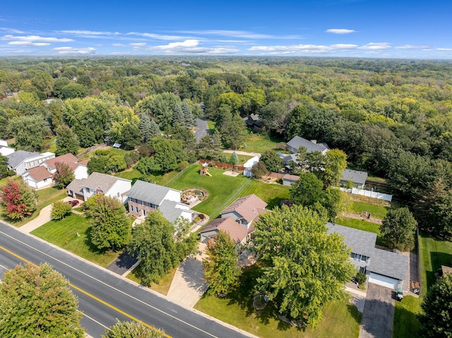 drone / aerial view featuring a residential view and a view of trees