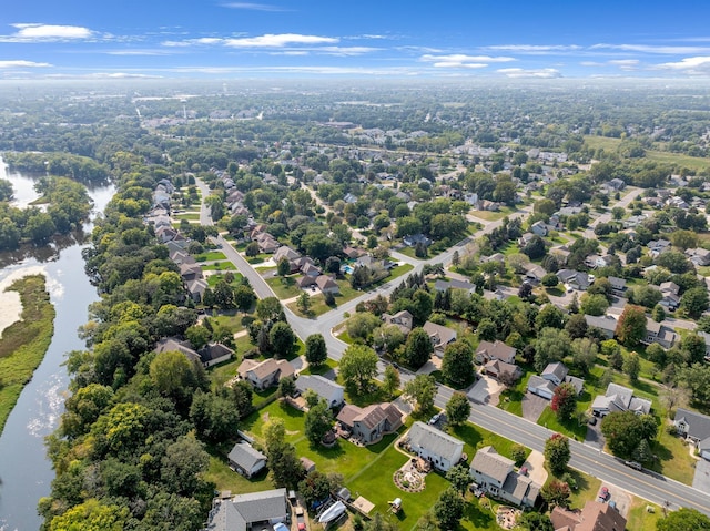 drone / aerial view with a water view and a residential view